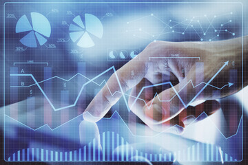 Multi exposure of man's hands holding and using a digital phone and forex graph drawing. Financial market concept.