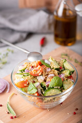 fresh vegetable and quinoa salad in a glass bowl on the table