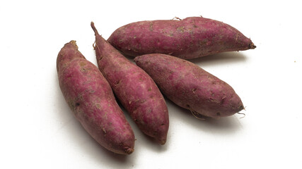 A group of raw sweet potatoes on isolated white background.