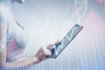 Double exposure of forex chart sketch hologram and woman holding and using a mobile device. Financial market concept.