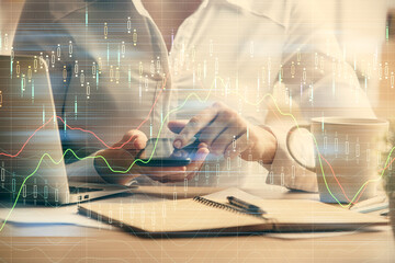Double exposure of forex chart sketch hologram and woman holding and using a mobile device. Financial market concept.