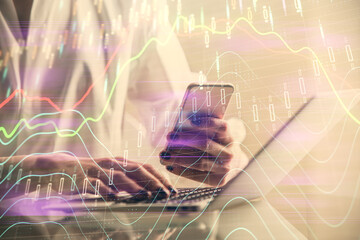 Double exposure of financial graph sketch hologram and woman holding and using a mobile device. Stock exchange concept.