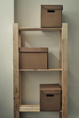 Paper boxes are on a wooden rack. Archive storage, use of eco-friendly materials