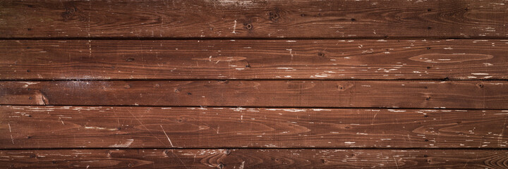 wide panoramic wooden scratched textured background of old long horizontal planks with peeling brown paint and nails. artistic image for stylish grunge rustic design