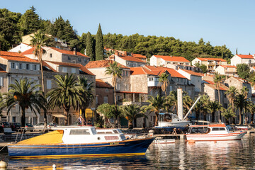 View of the bay with yachts, palm trees and houses on the island of Korcula, Croatia