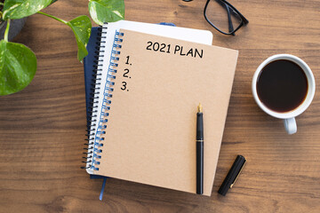 Note book with 2021 goals text on it to apply new year resolutions and plan.