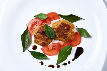 vegetarian cabbage cutlets with tomatoes. decorated with fragrant leaves.