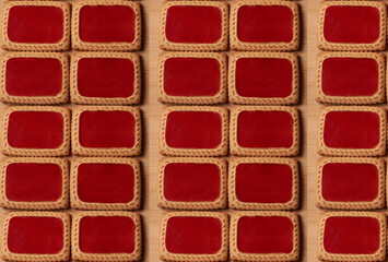 Fifteen handmade cookies with currant jam, arranged in even rows