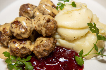 A delicious plate of Swedish meatballs with mash potatoes and lingonberry sauce