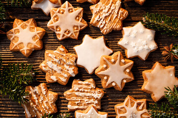 Christmas gingerbread stars on a wooden background, close up view. Delicious festive dessert