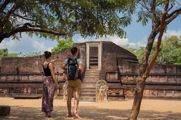 a couple visit beuatiful temple in archeological site of Polonnaruwa, Sri Lanka