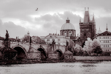 View of Charles Bridge and Old Prague district with medieval churches and towers in Prague, Czech...
