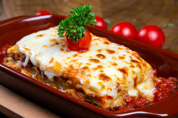 Italian cuisine, piece of tasty hot lasagna served