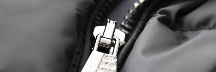 Black jacket has metal zip fastened. Repair of clothes and accessories concept
