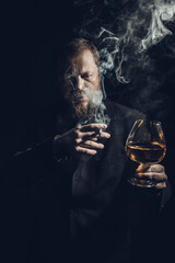 Solid confident bearded man in suit with glass of whisky and cigar with fume