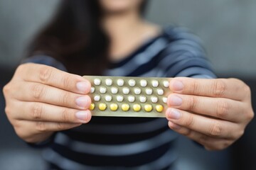 Concept birth control.Woman holding contraception pills.