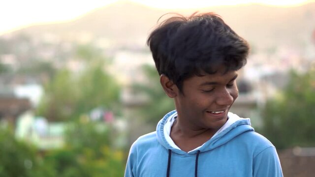 Extremely happy Indian kid swirling his head in joy