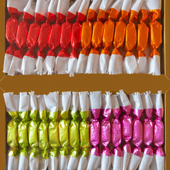 two sets of candies in colored tinfoil for a Christmas tree, candies wrapped in colored foil 