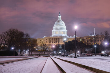 United States Capitol Building in winter night with snow-covered grounds - Washington D.C. United States of America