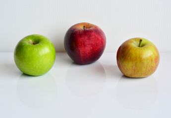 Red and green apples isolated on white background with reflection