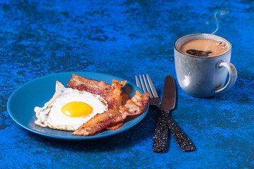 English fried eggs with bacon and coffee