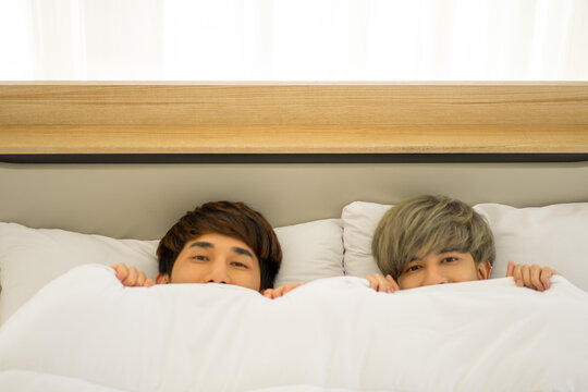 Asian men same sex love marriage LGBTQ on bed during holiday having good time. 