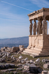 Obraz premium The Erechtheion or Erechtheum, an ancient Greek temple on north side of the Acropolis of Athens in Greece, dedicated to Athena and Poseidon, Greek Gods, overlooking Athens, Greece.