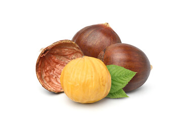 Close-up Chestnuts with peeled with green leaves isolated on white background.