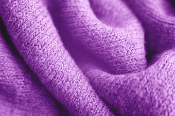 Fototapeta na wymiar Close up of purple knitted textured background. Trendy color.
