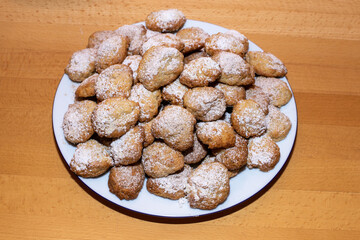 plate with Christmas cookies on a bright wooden table