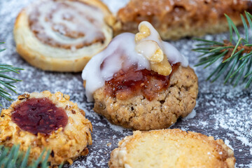 Close-up of various Christmas cookies surrounded with powdered sugar