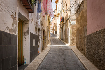 Fototapeta na wymiar a narrow cobbled street with traditional old houses in Tarazona city, province of Zaragoza, Aragon, Spain