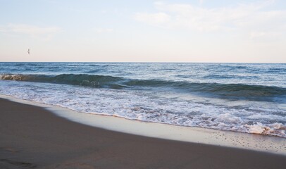 Sea beach with blue sky and yellow sand and some clouds