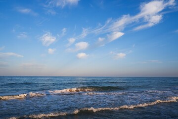 Sea beach with blue sky and yellow sand and some clouds