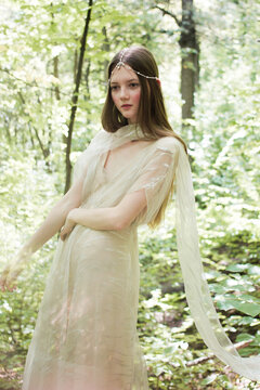 Portrait of a woman in a forest. Space for text. The concept of fashion. Magic fabulously fairytale photo. 
bride in nature