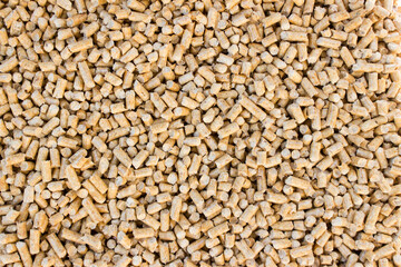 Wooden pellets background, pattern. Close up natural wood pellet. Ecological heating, renewable energy. Flat lay ecological fuel for heaters.