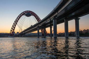 A beautiful picturesque bridge in Moscow. Unusual architecture. Bridge on the background of sunset. Bridge over the river. Quiet winter evening