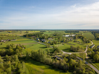 Fototapeta na wymiar summer fields forests and roads in countryside view from above drone image