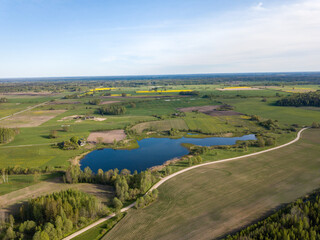 Naklejka premium summer fields forests and roads in countryside view from above drone image