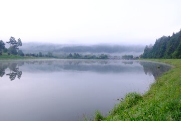 Fototapeta premium Beautiful view of Krempna reservoir on magical sunny morning. Reflections in the water. Low Beskids Mountains, Poland