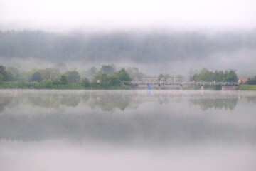 Misty view of Krempna reservoir and bridge on magical morning. Low Beskids Mountains, Poland