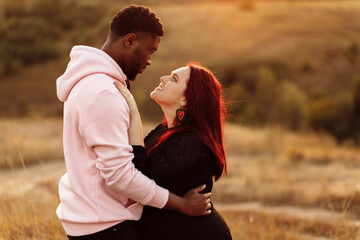 Portrait of attractive African American man gently hug beautiful white woman, adorable lady smiling, enjoy tender moments, spend time together, mixed race couple concept