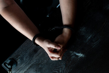Fototapeta na wymiar hands in handcuff on table