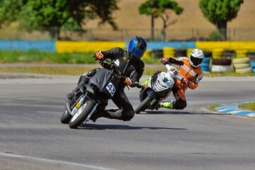 Motorcycle practice leaning into a fast corner on track