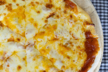 Homemade Pizza made from dough topped with spices like ham, sausage , vegetables and cheese