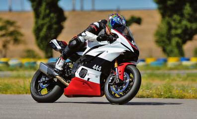 Fototapeta premium Motorcycle practice leaning into a fast corner on track