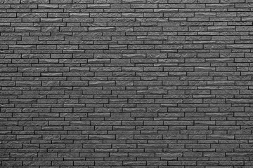 black wall made of decorative bricks, smooth texture