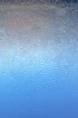 Natural frozen drops of condensation on transparent glass. Beautiful background from a frozen...