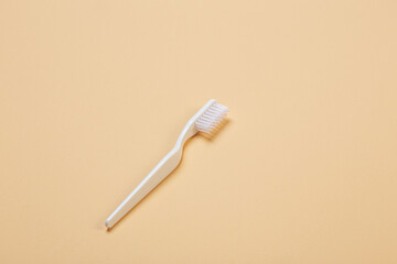 white toothbrush on beige background