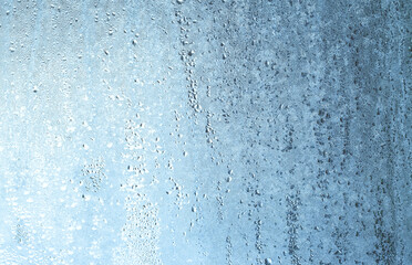 Natural frozen drops of condensation on transparent glass. Beautiful background from a frozen...